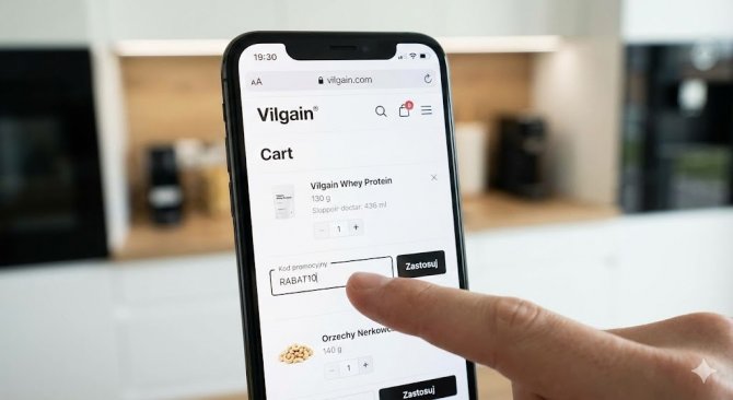 Okostelefon képernyője a Vilgain webáruház kosarával, ahol a felhasználó beírja a kuponkódot a kedvezmény érvényesítéséhez.